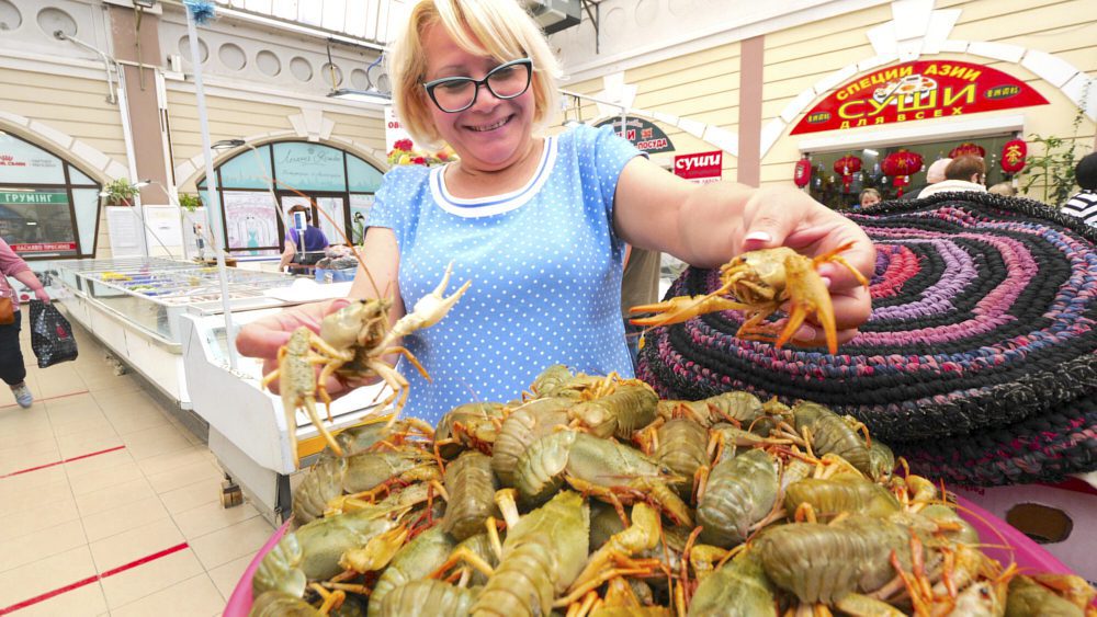 A vendor showing off her crayfish 