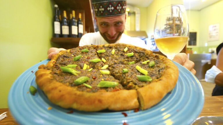 David Hoffmann showing off the khachapuri at Poliphonia Wine Bar