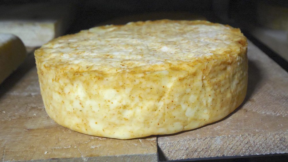 A wheel of cheese on a shelf at Tsivis Kveli 