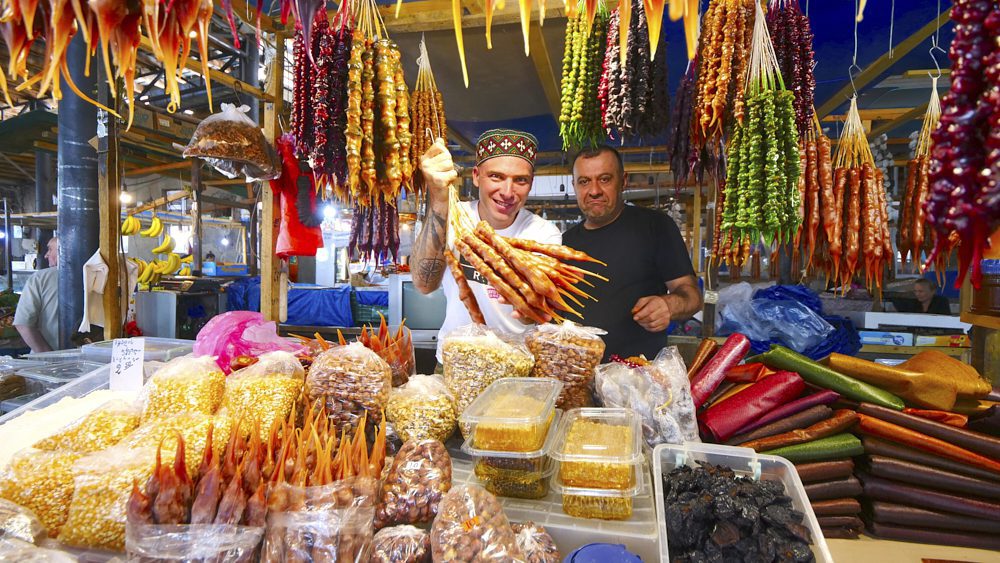 David Hoffmann with a churchkhela vendor at Telavi Bazaar