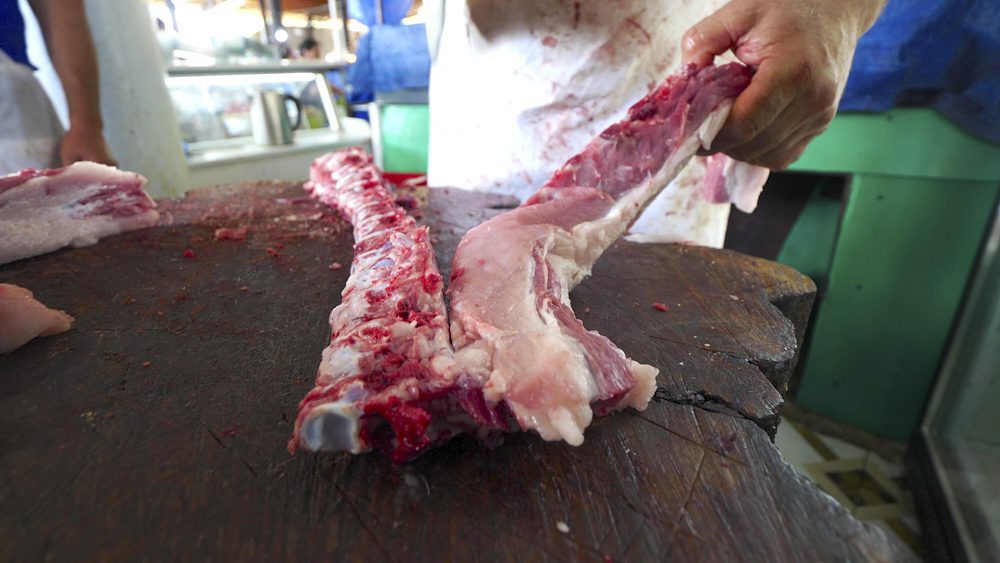 A piece of meat being cut by a butcher at Telavi Bazaar