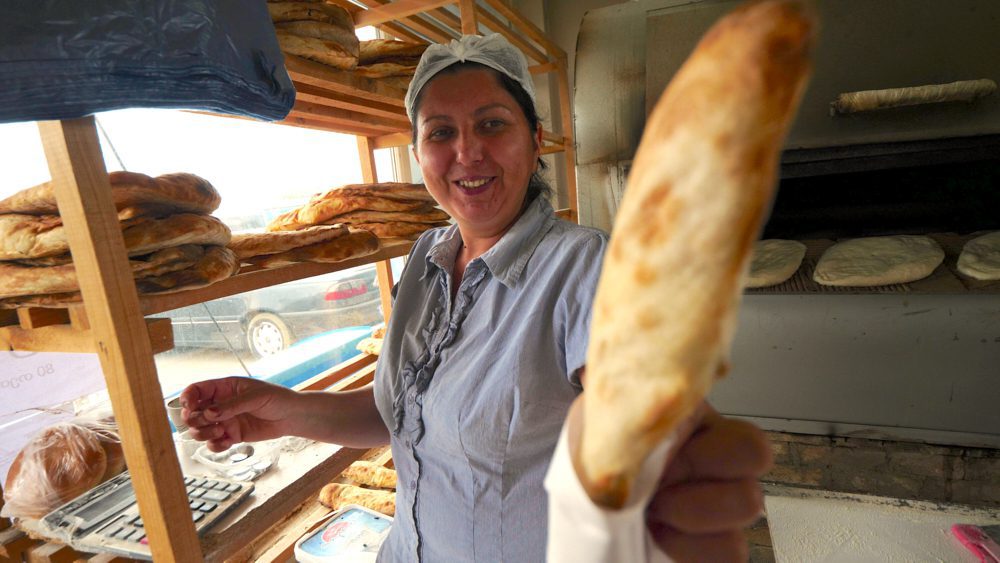 A local woman holding freshly-made bread