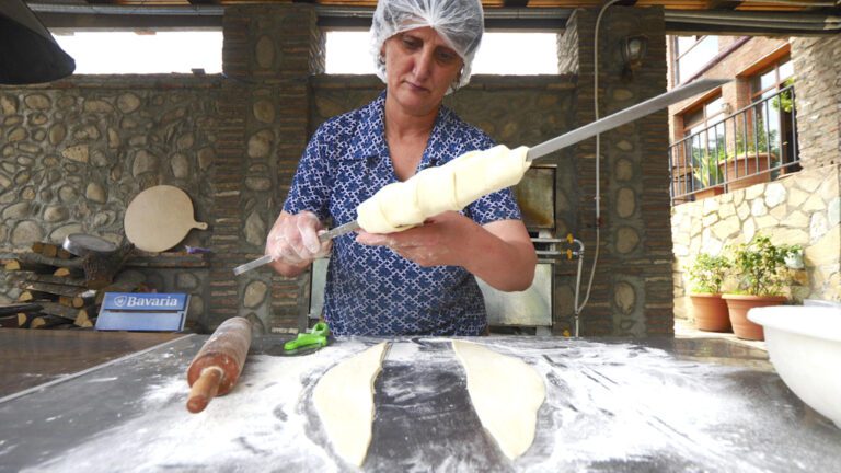 A woman preparing a khachapuri kebab at Kusika Restaurant