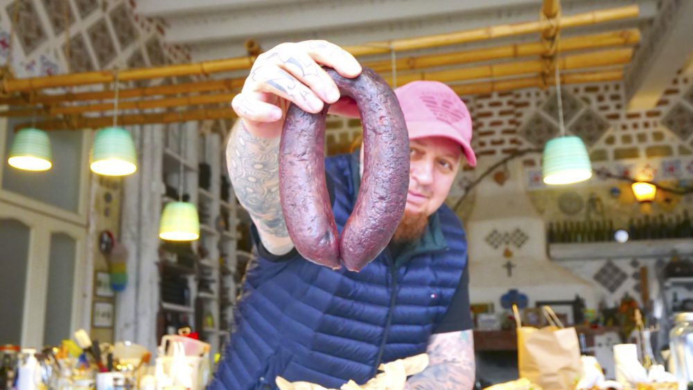 Alejandro holding a sausage at Don Alejandro Winery