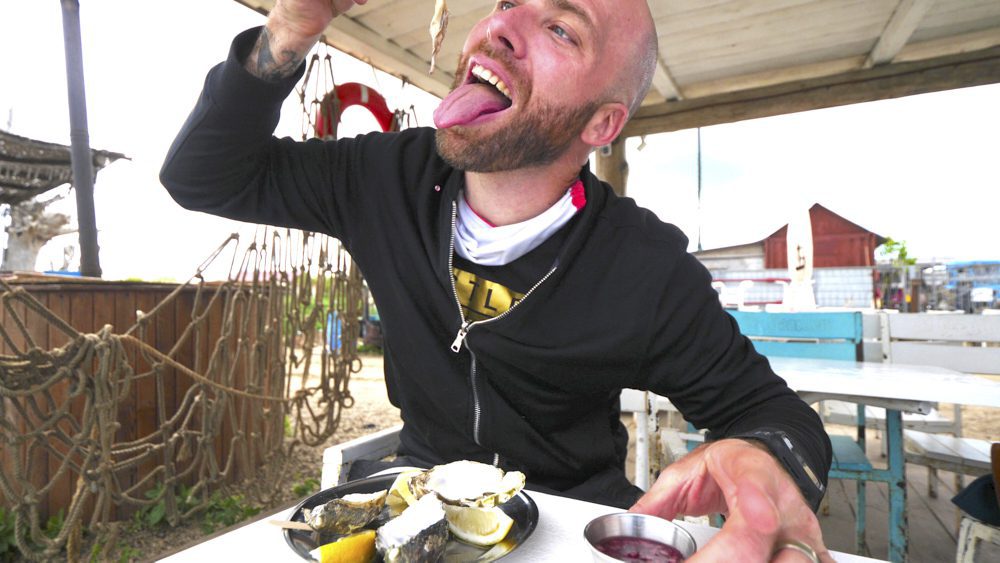 David Hoffmann eating a raw oyster at Chernomorka Restaurant in Mykolaivka, Ukraine