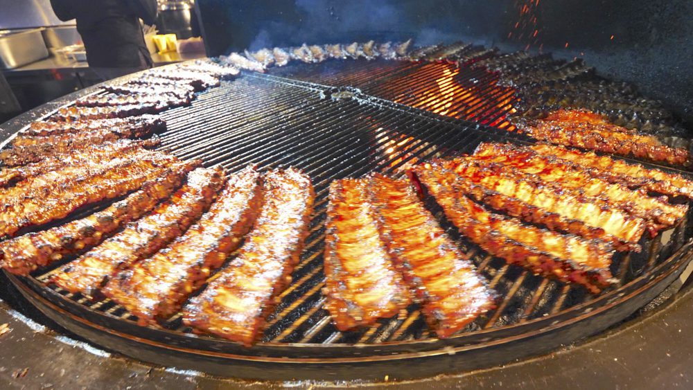 Ribs cooking on the circular grill at Rebernia in Odessa