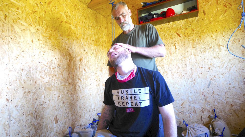 David Hoffmann receives a traditional chiropractic treatment in Marynivka, Ukraine