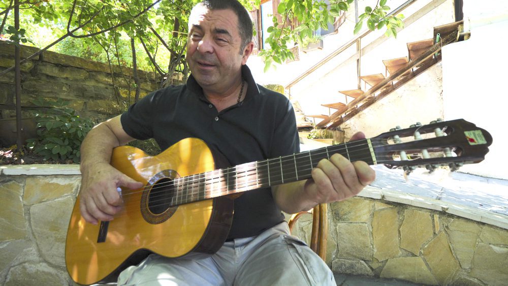 A man singing with his guitar in Mtskheta, Georgia