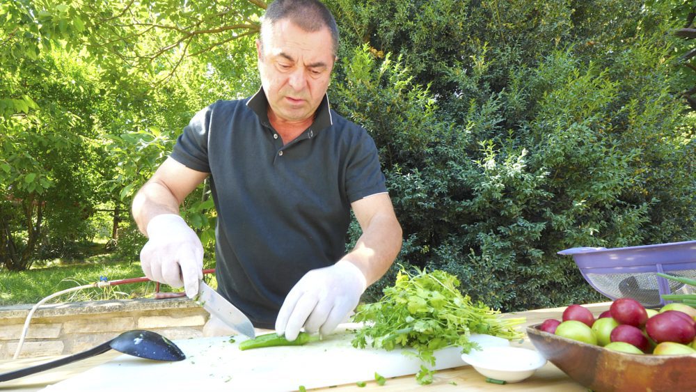 A Georgian man cutting vegetables in Mtskheta, Georgia