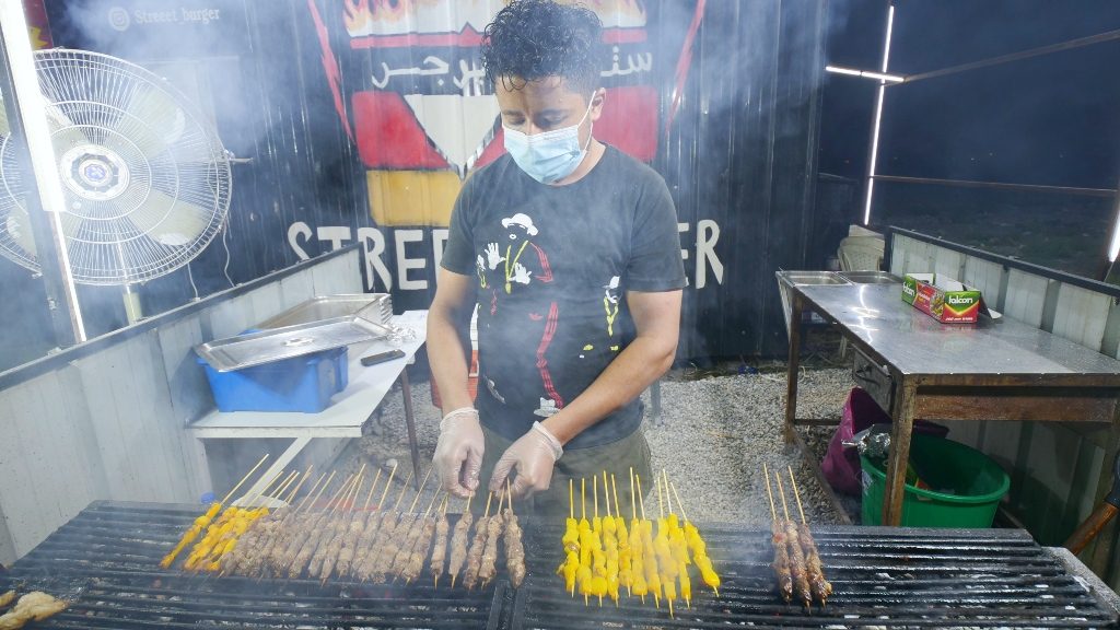 A vendor grills different types of mishkak, a popular Oman street food, in Muscat, Oman. 
