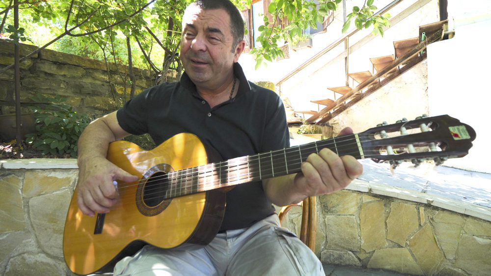 A local man plays the guitar at his home near Tbilisi, Georgia