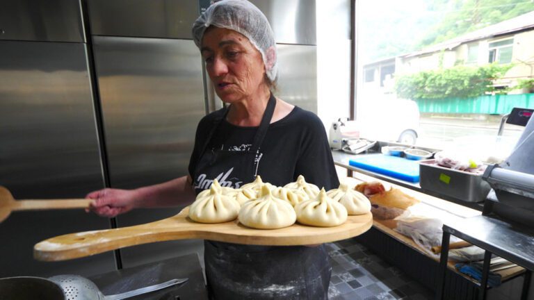 A woman making khinkali at Guda Restaurant