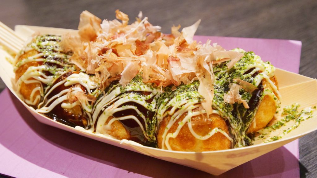 Takoyaki topped with various sauces, bonito flakes, and seaweed | David's Been Here