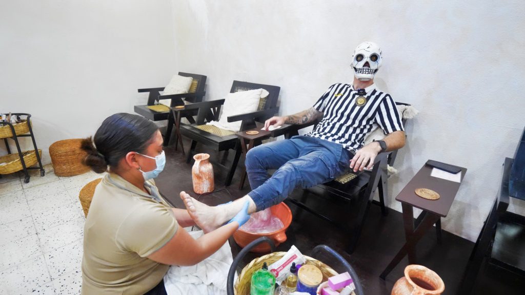 Getting a foot massage while wearing a skull mask in Granada | David's Been Here