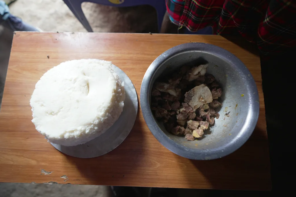 Freshly cooked lamb and ugali made by members of the Maasai tribe | Davidsbeenhere