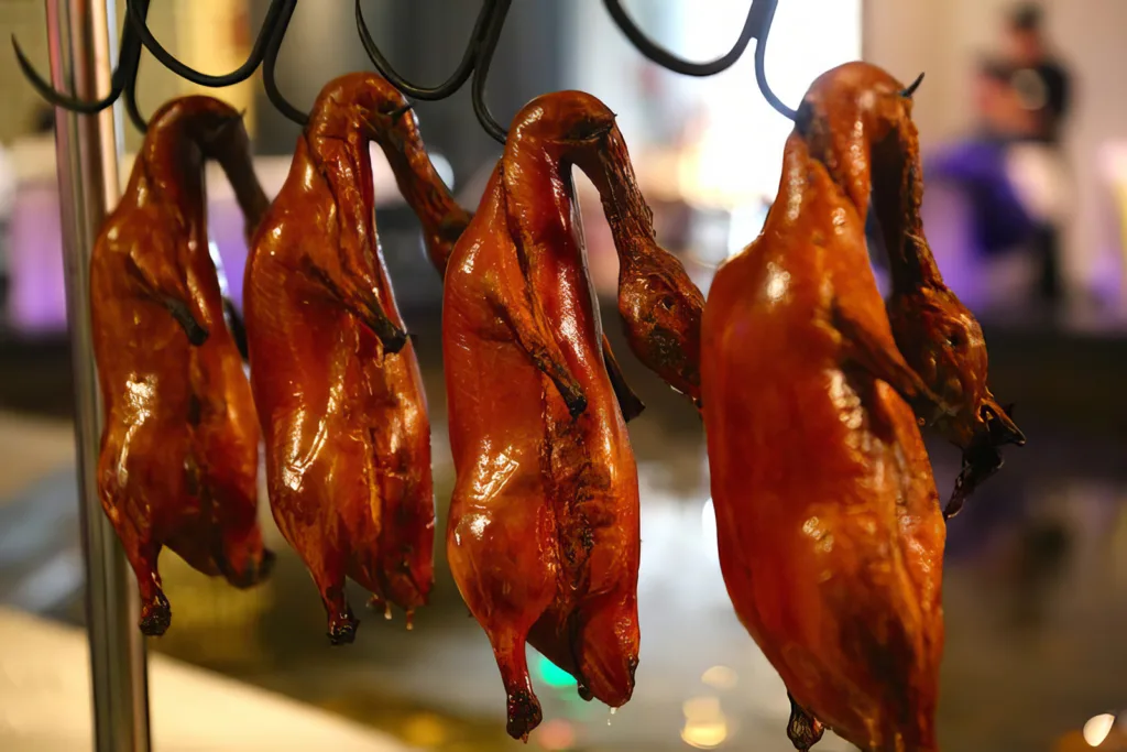 Roasted Peking ducks hanging by hooks in Shanghai | Davidsbeenhere
