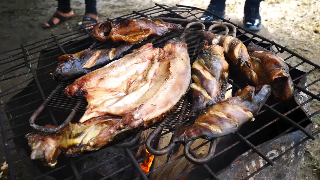 Fresh fish being grilled on an outdoor grill to make tuma | Davidsbeenhere