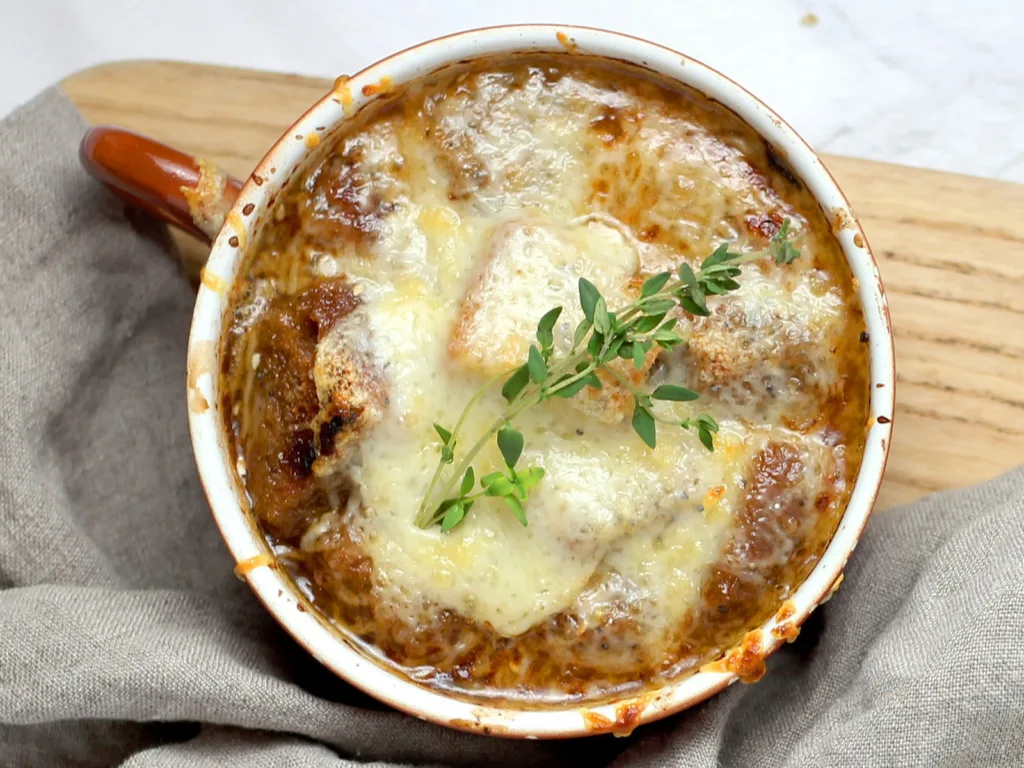 Soupe à l'oignon, or French onion soup, with melted cheese on top | Davidsbeenhere