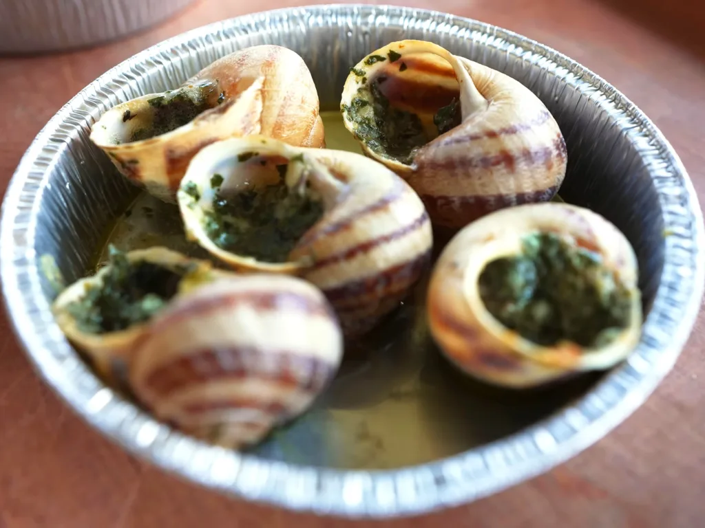Escargot, a traditional dish made from snails cooked in garlic butter and served in their shells | Davidsbeenhere