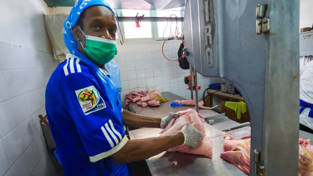 A butcher cutting meat in Cheapside Market | Davidsbeenhere