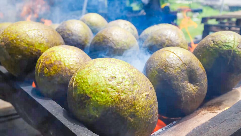Fresh breadfruit roasting over a fire in Barbados | Davidsbeenhere