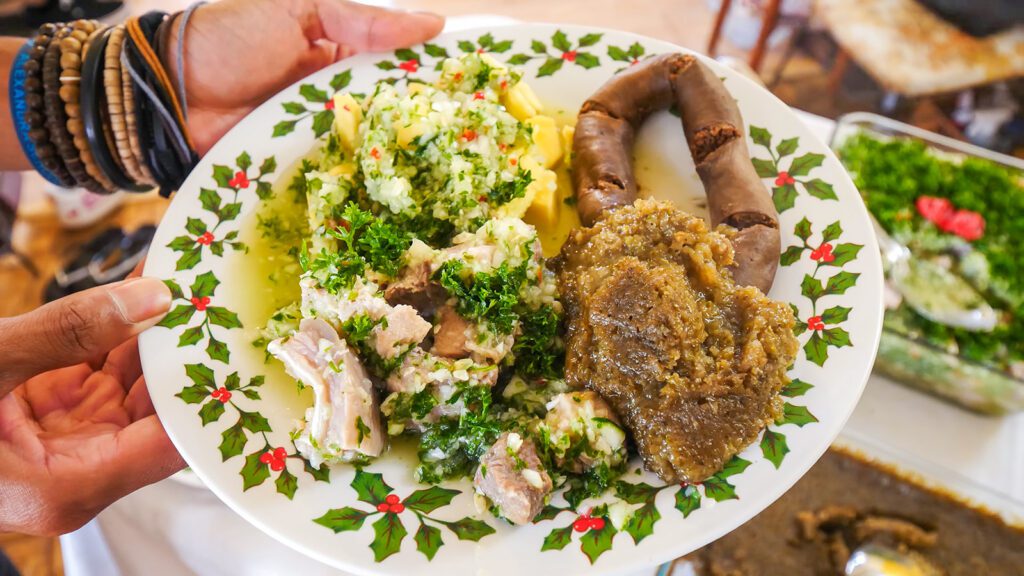 A plate of black pudding, souse, breadfruit, and steamed pudding in Barbados | Davidsbeenhere