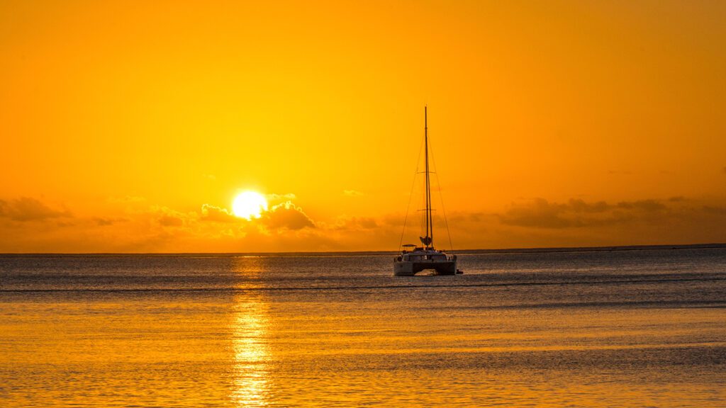 A small boat on the water at sunset in Bora Bora | Davidsbeenhere