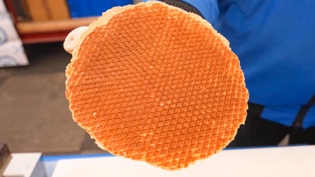 A freshly made, golden brown stroopwafel filled with caramel | Davidsbeenhere