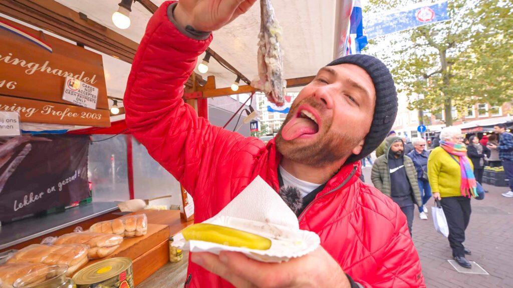 David Hoffmann takes a bite of a traditional Dutch herring at Albert Cuyp Market in Amsterdam, the Netherlands | Davidsbeenhere