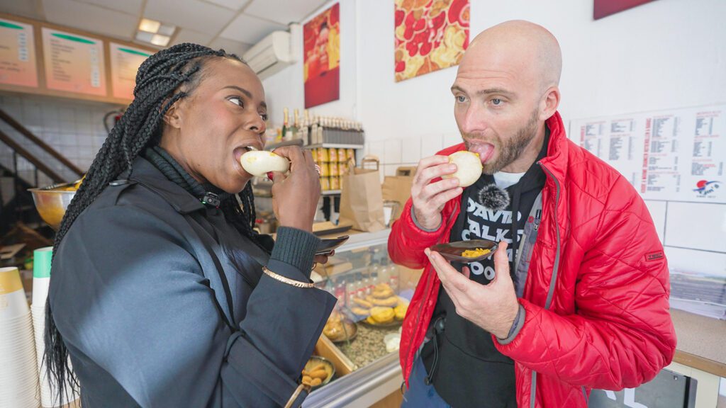 David Hoffmann and his guide Melissa eating Surinamese pom buns at Warung Mini in Amsterdam | Davidsbeenhere