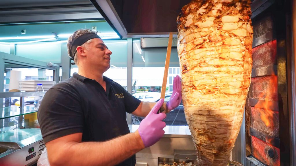 A cook slices chicken shawarma, a popular food in Rotterdam, off a rotating spit | Davidsbeenhere