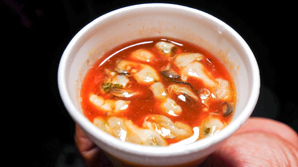 A styrofoam cup of spicy oyster soup sold by a famous street vendor in Queen's Park Savannah in Port of Spain, Trinidad | Davidsbeenhere