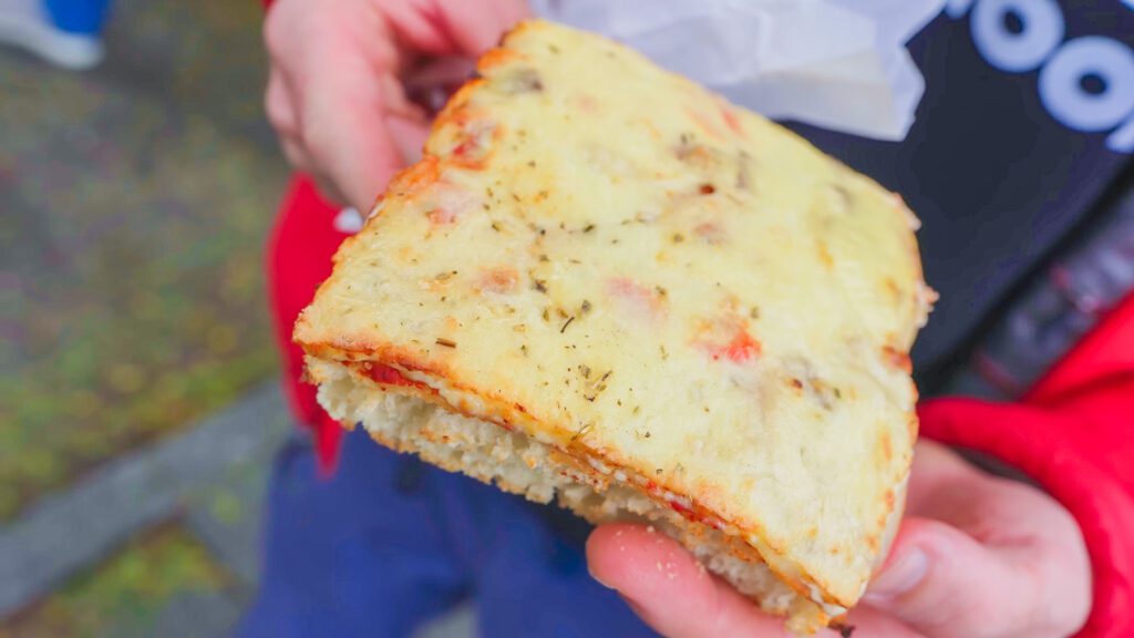 A square-shaped slice of thick-crust pizza at the Rotterdam market, Blaak Market | Davidsbeenhere
