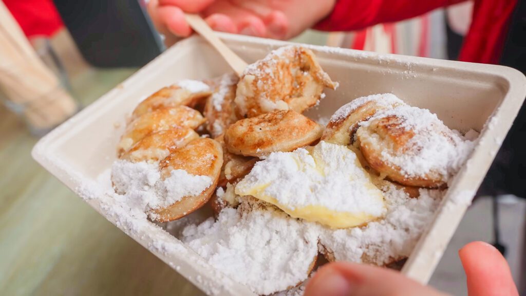 Fresh poffertjes topped with butter and powdered sugar | Davidsbeenhere