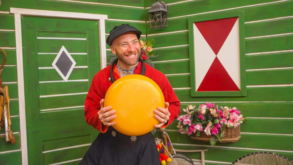 David Hoffmann poses with a fake wheel of cheese in traditional Dutch clothing in Volendam, a city famous for its smoked eel | Davidsbeenhere 
