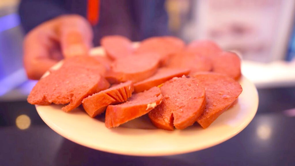 A plate full of sliced rookworst, a traditional Dutch sausage | Davidsbeenhere