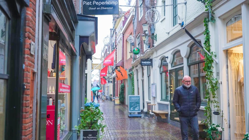 A narrow, shop-lined street in the city of Alkmaar, the Netherlands | Davidsbeenhere