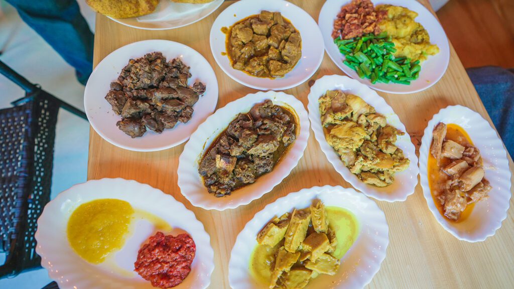 A spread of Surinamese dishes, including chicken liver, sambal, curry lamb, green beans, and spicy chicken | Davidsbeenhere