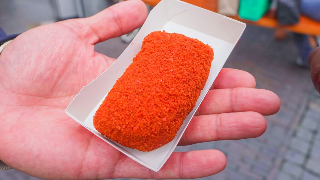 A bright orange bamischjif, or bami croquette in Utrecht, the Netherlands | Davidsbeenhere