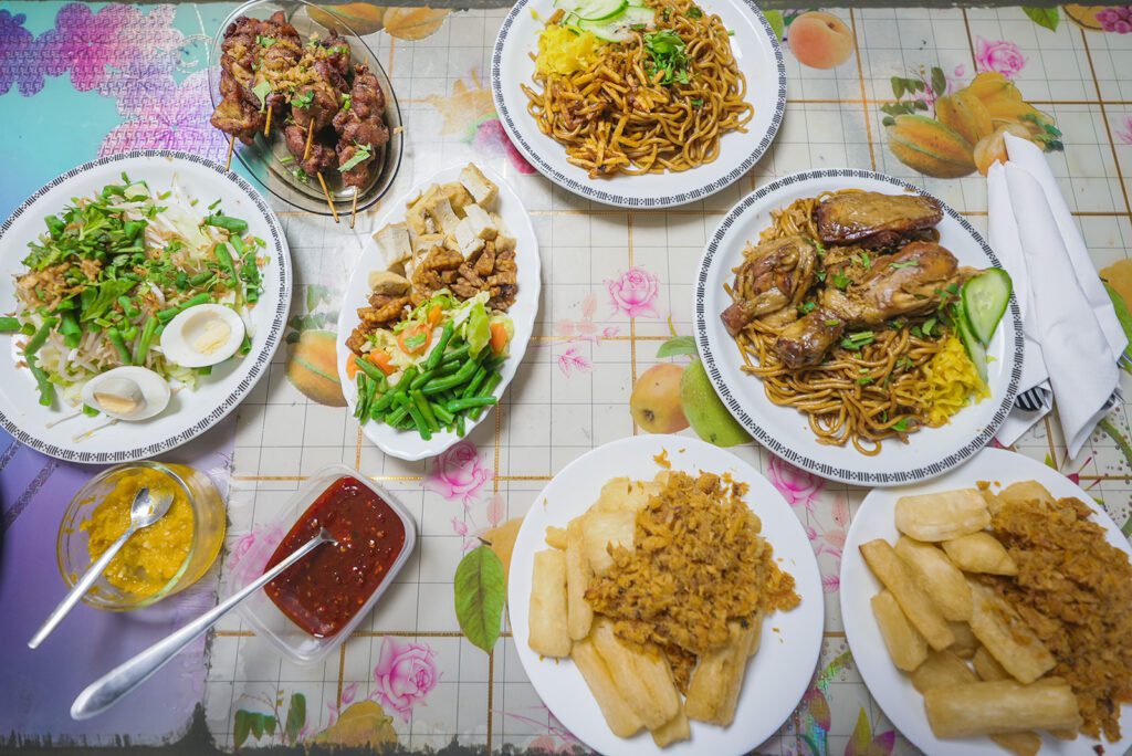 A Surinamese-Javanese spread at Warung Tresno, including fried yuca, saltfish, chicken sate, noodles, and more | Davidsbeenhere