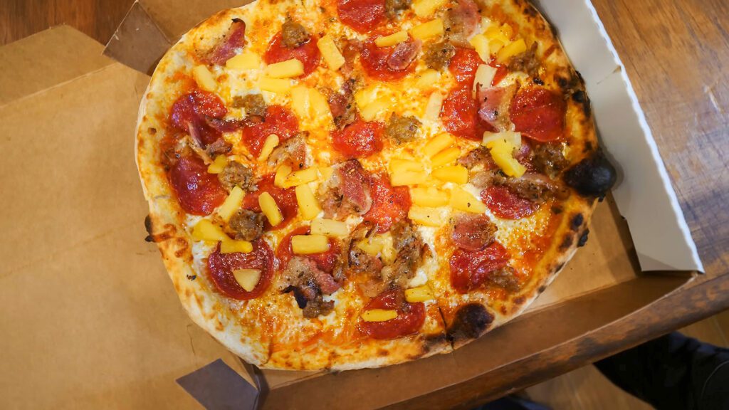The pineapple, bacon, sausage, and pepperoni pizza at Pepe's Pizza in Crown Point, Tobago | Davidsbeenhere