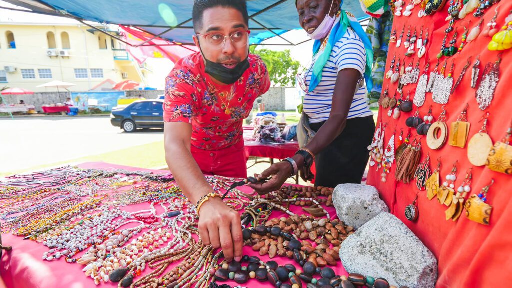 Chef Jason Peru browses the handmade jewelry at a local market in Tobago | Davidsbeenhere