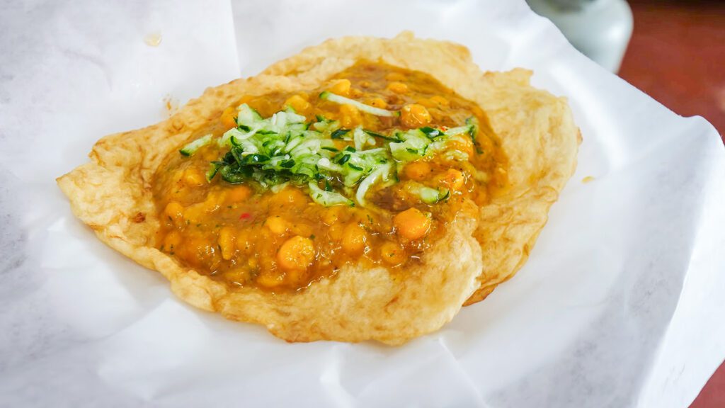 Doubles (a pair of flatbread called bara, topped with chickpea curry, cucumber, and chutneys), one of the top Caribbean dishes in the world | Davidsbeenhere