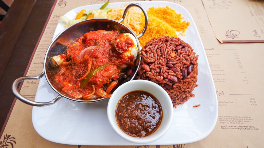 A plate of waakye, a popular food in Ghana, along with pasta, vegetables, and gari | Davidsbeenhere