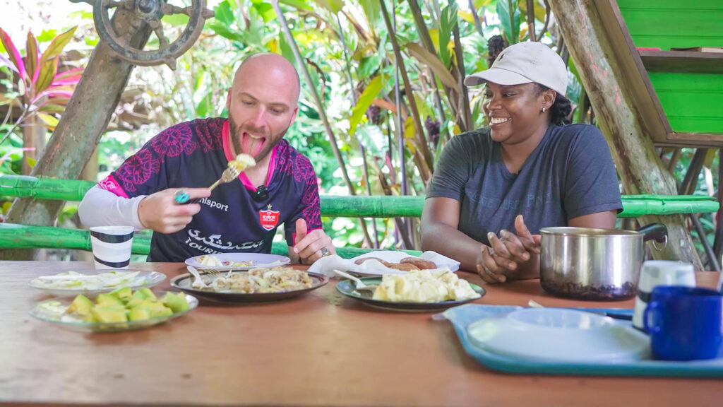 David Hoffmann eats Dominican bush food at the Indian River Bush Bar as the cook, Alicia, looks on | Davidsbeenhere