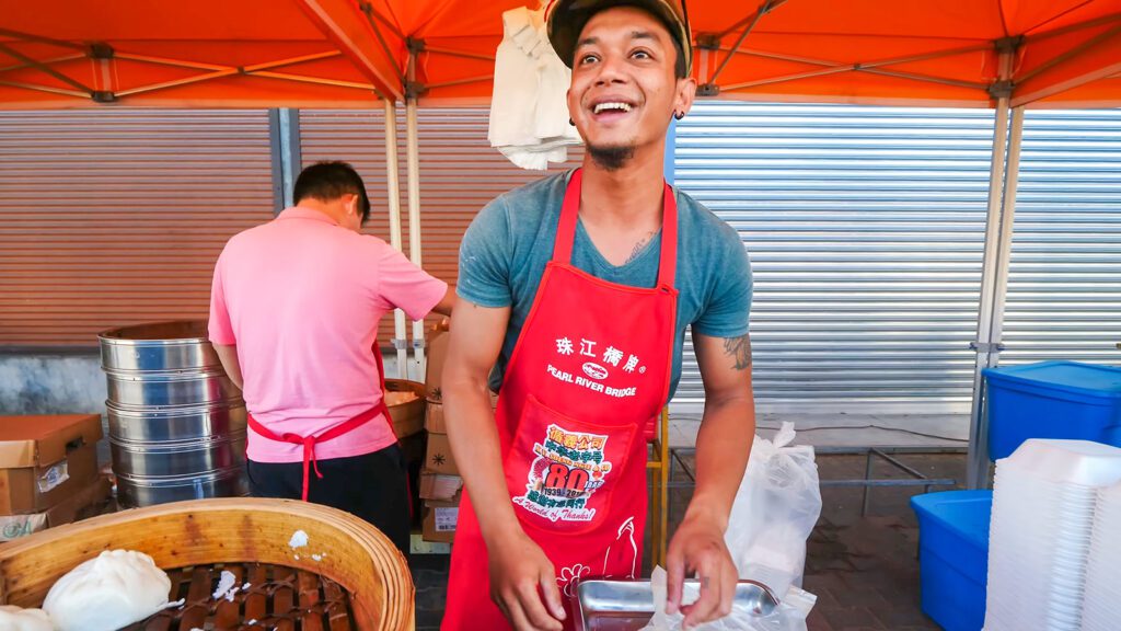 A Surinamese man sells Chinese street food in a market in Paramaribo, Suriname | Davidsbeenhere