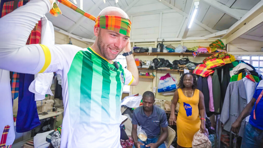 David Hoffmann tries on a head scarf at Universal Tailor Shop in Portsmouth, Dominica | Davidsbeenhere