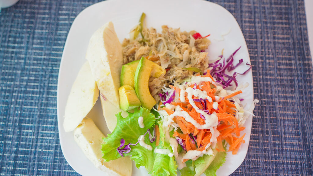 A typical Dominican breakfast, consisting of roasted breadfruit, saltfish, and a fresh salad | Davidsbeenhere