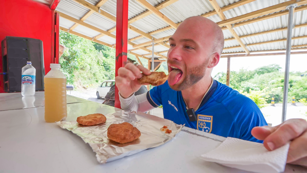 David Hoffmann takes a bite of a freshly made bake in Dominica | Davidsbeenhere