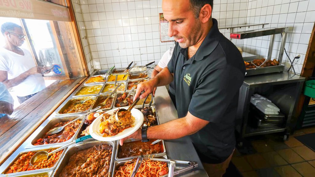 Noam builds a plate of Haitian food favorites at Naomi's Garden in Miami | Davidsbeenhere